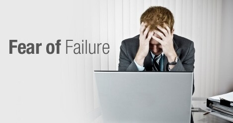 A man afraid at his computer, demonstrating "Fear of Failure"