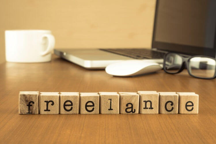 Blocks that read "freelance" with a laptop in the background