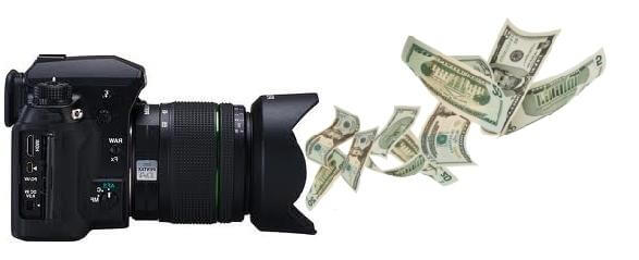 A camera that is facing money dispersed in the air