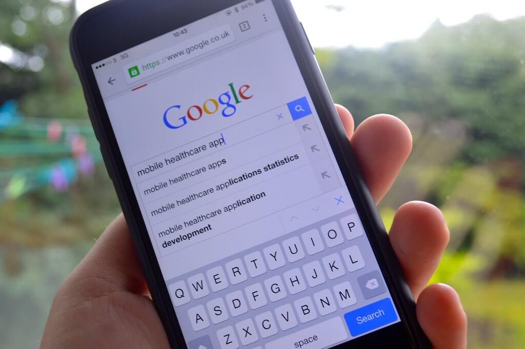 A person showing Google on their smartphone